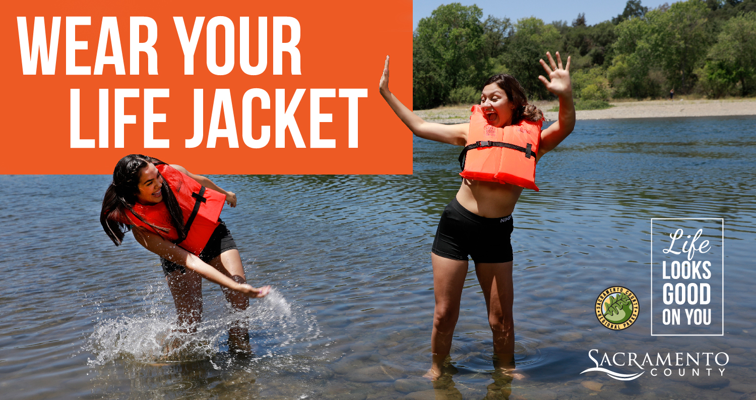 Wear your Life Jacket - lifelooksgoodonyou.org - Two women splashing in the river.